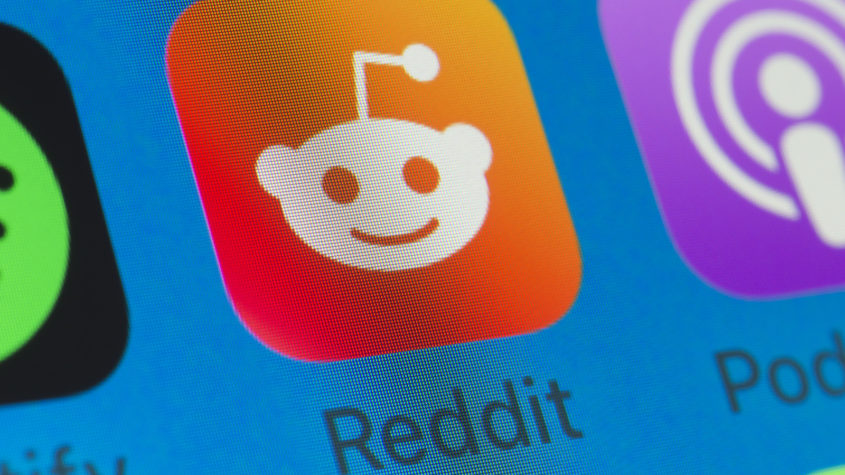 Reddit, Spotify, Podcasts and other cellphone Apps on iPhone screen